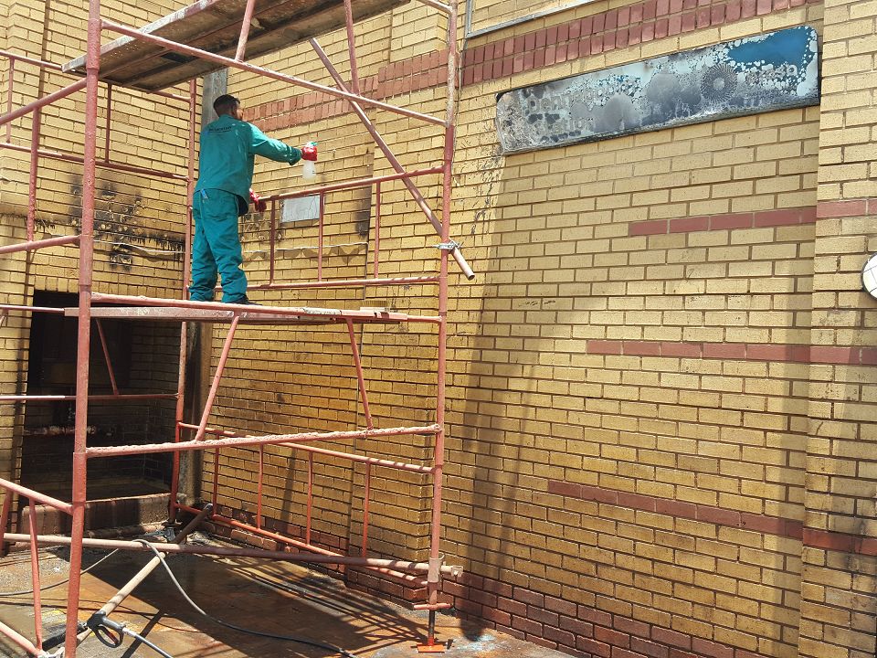 Building maintenance work on scaffolding at a Blue Star project